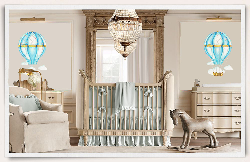 Blue hot air balloon wall decals with watercolor clouds above crib in luxury baby nursery room