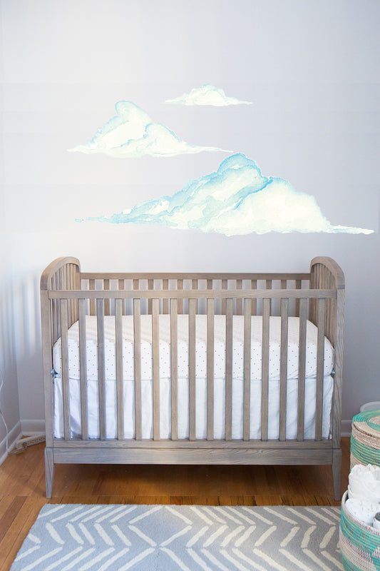 Watercolor cloud wall decal set above crib for baby nursery room decor