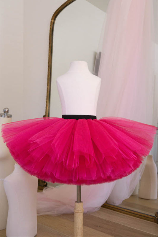 Hot pink tulle tutu skirt with black waistband for girls displayed on mannequin