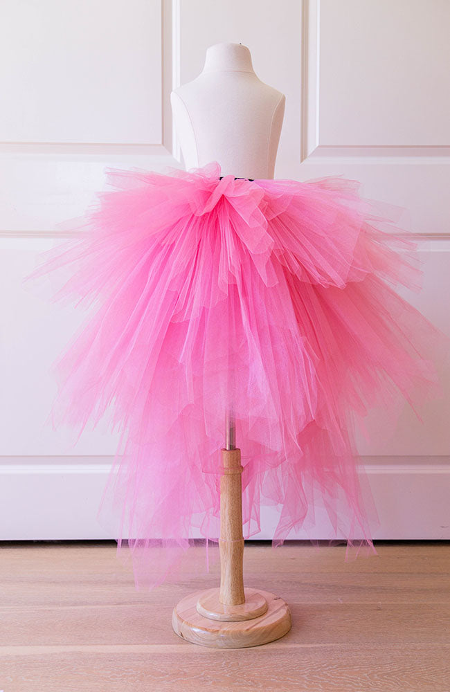 Pink tulle skirt for girls displayed on mannequin, perfect for birthdays, parties and dress up