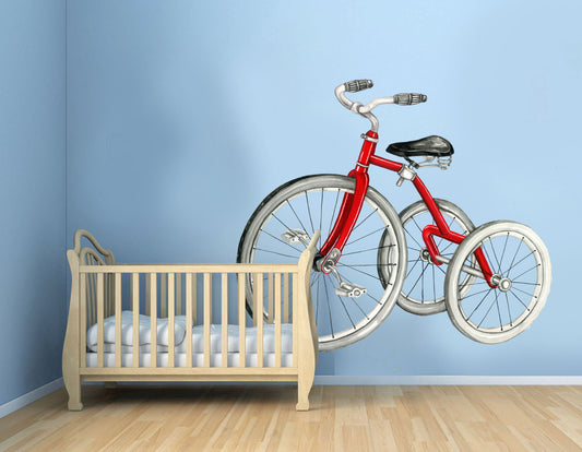 Red vintage bicycle wall decal on blue nursery wall above wooden crib
