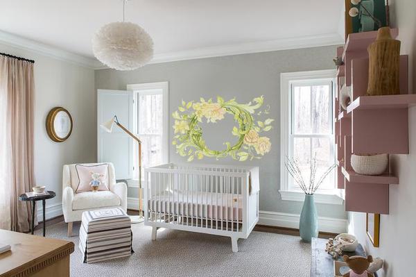 Vine floral wall decal with yellow flowers above white crib in modern baby nursery room
