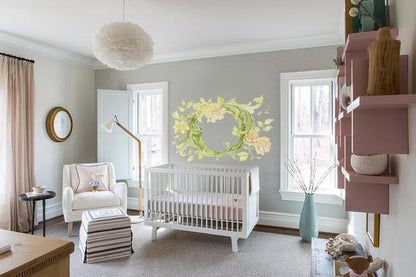 Vine floral wall decal with yellow flowers above white crib in modern baby nursery room
