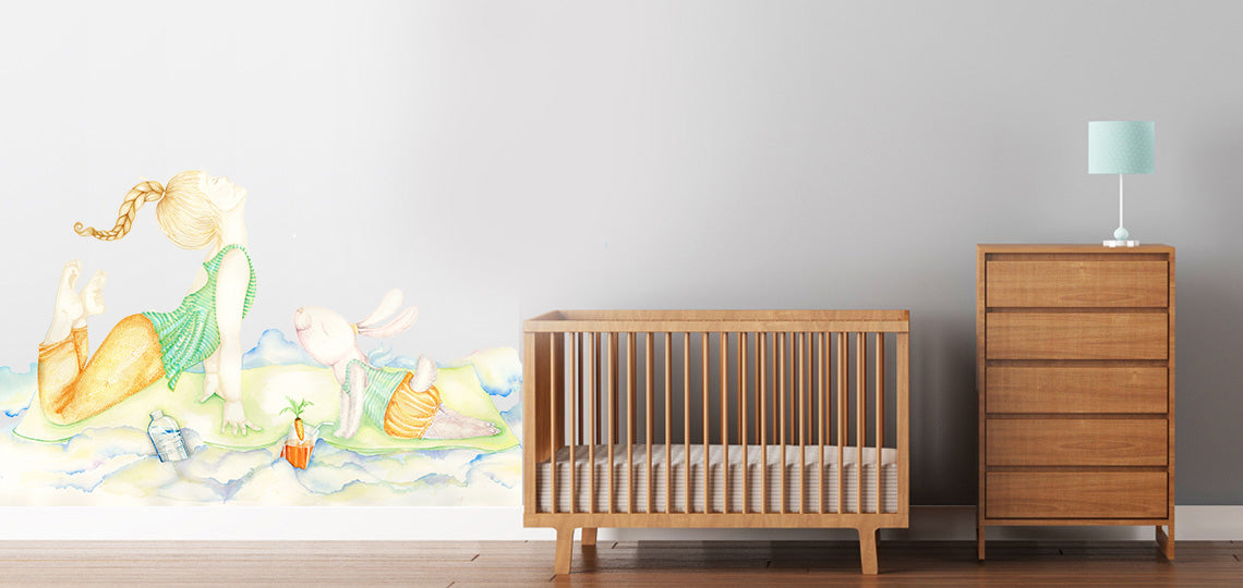 Yoga girl wall decal on nursery room wall behind white kids bed